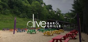 Dive Bar & Grille logo over image of picnic tables.