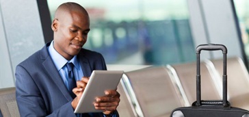 man at airport with tablet