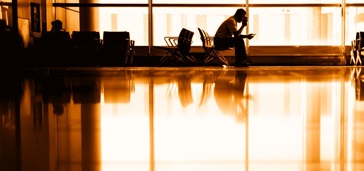 people in waiting area at the airport, orange-gold tint
