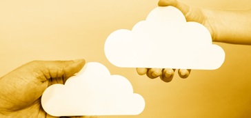 hands holding paper clouds, light to dark yellow gradient background