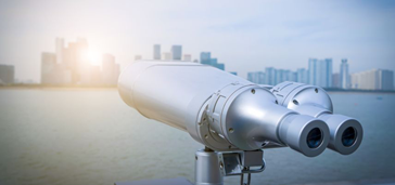 Binoculars overlooking water and city
