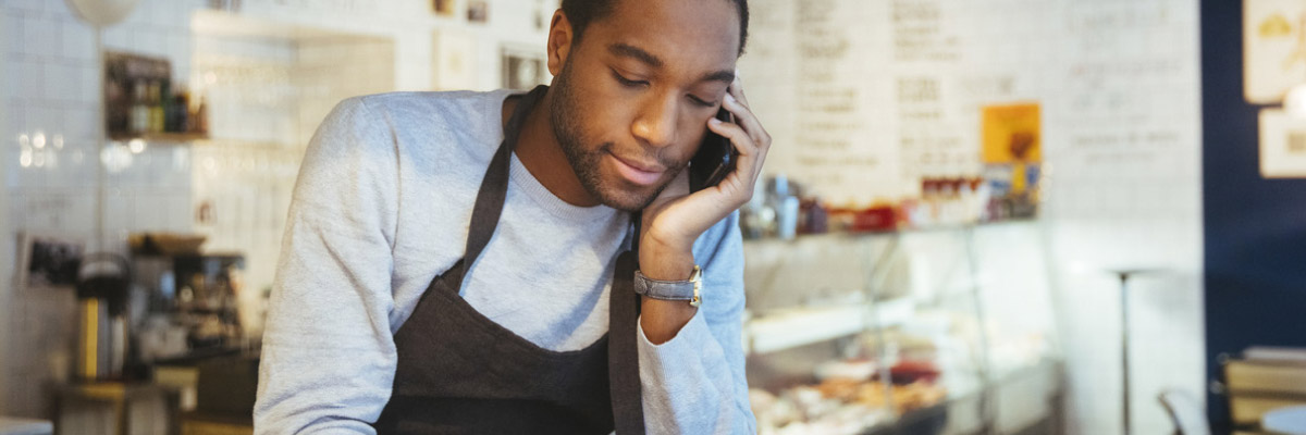 Man in apron on phone